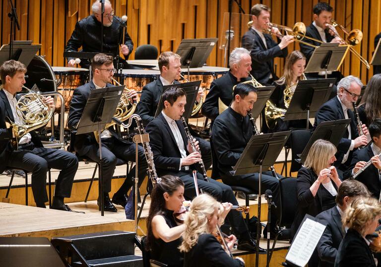 London SymphonyOrchestra performing on the Barbican Hall stage.