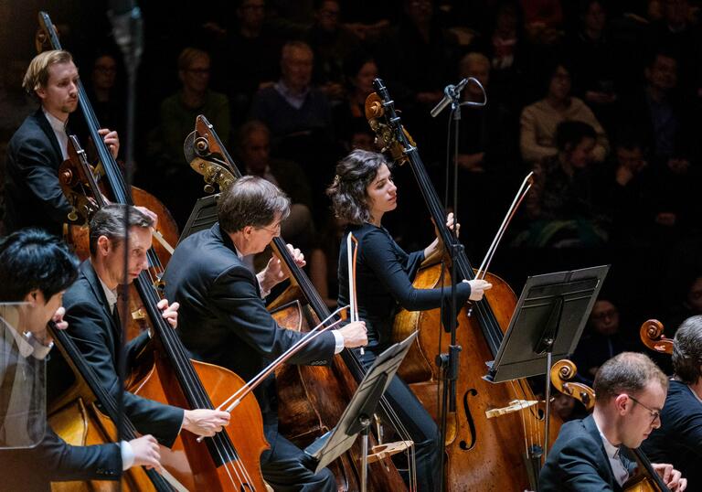 London SymphonyOrchestra performing on the Barbican Hall stage.