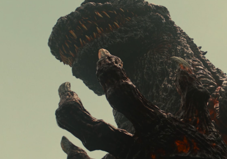 A monster appears in a dark skyline.