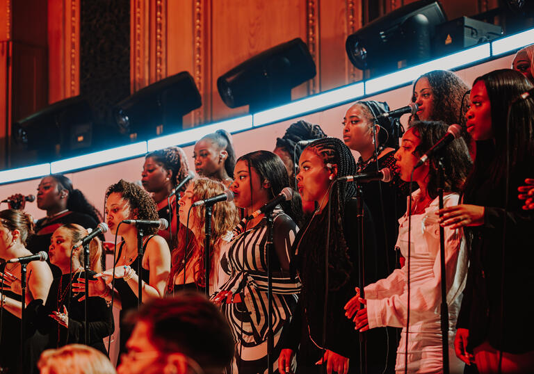 Singers in the gospel choir performing on stage