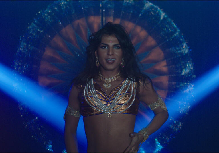 A drag queen performs on stage