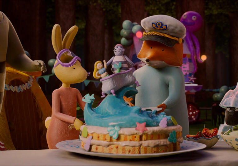 A group of animals stand in a house around a birthday cake. 