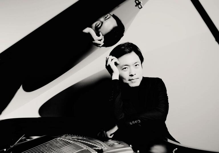 Sunwook Kim sitting at a grand piano