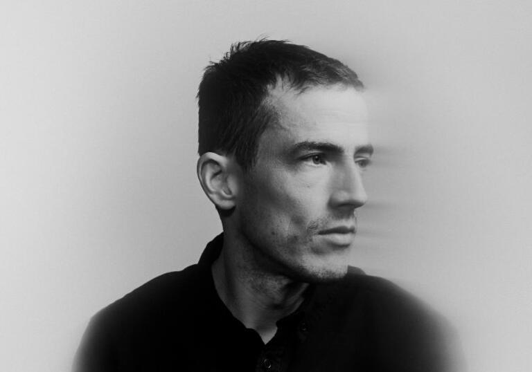 Charlie Cunningham in blurred, black and white image looking to the right pensively