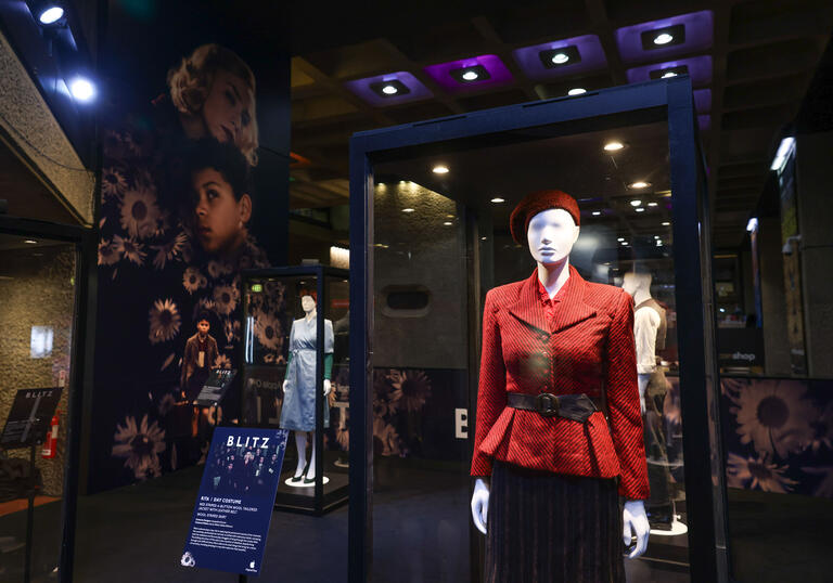 An image of a costume exhibition showing WWII outfits.