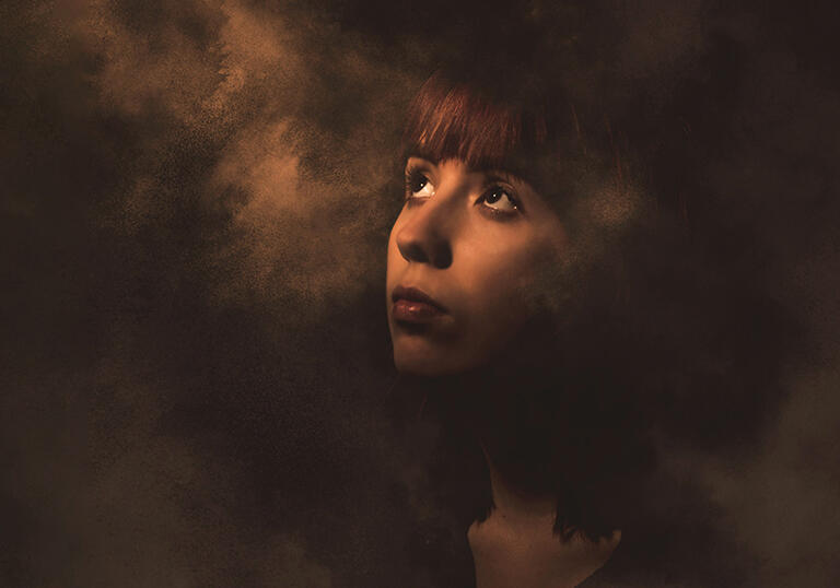 Mansfield Park artwork - a young woman looking up surrounded by smokey haze