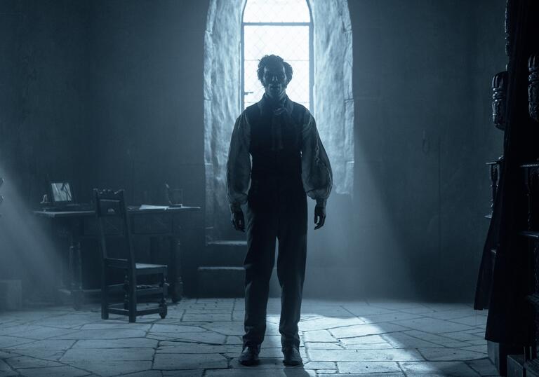 Nicholas Hoult stands in room