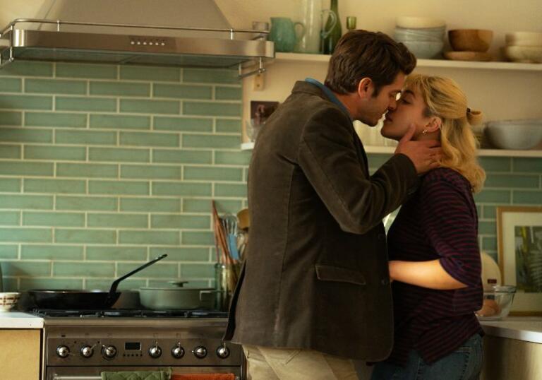 Andrew Garfield cups Florence Pugh's face, as they are about to kiss