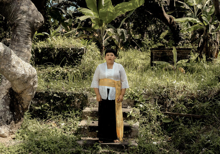 Citra Sasmita stands in a lush, green garden