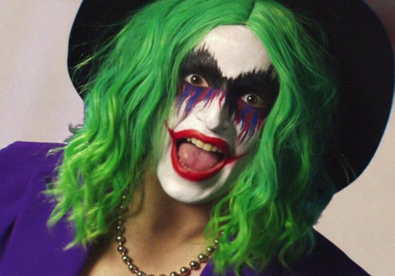 Vera Drew dressed as the Joker looks into the camera,