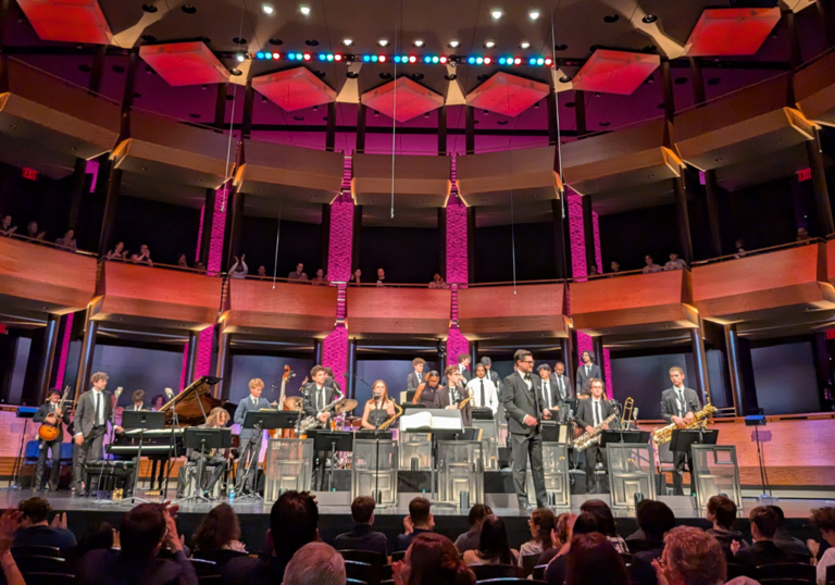 A jazz orchestra on stage with an audience