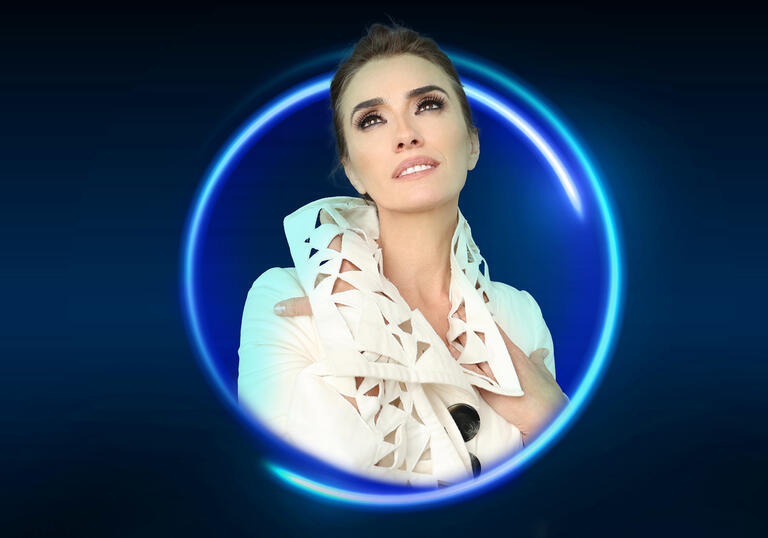 An image of Ermonela Jaho posing surrounded by a blue circle against a blue background
