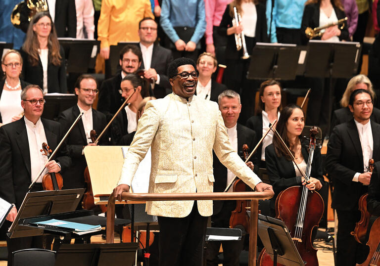 Andre J Thomas facing the audience in the Barbican concert hall
