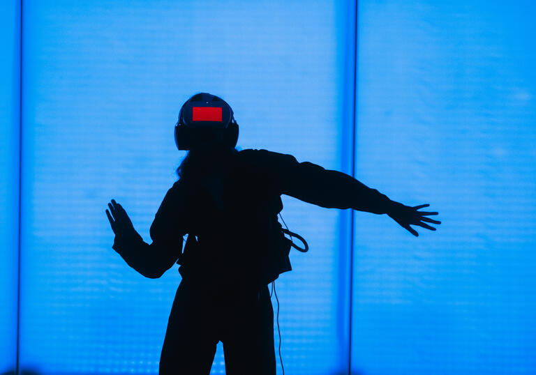 A person wears a headset, immersing themselves in a VR world