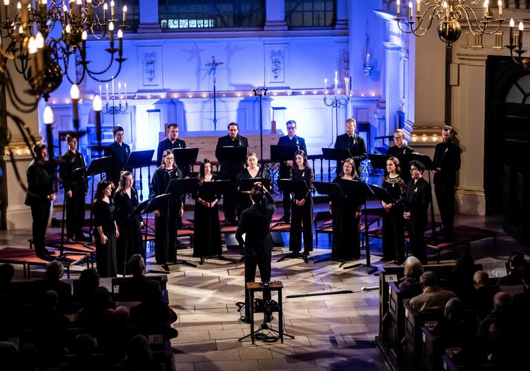 A choir singing on stage in a church