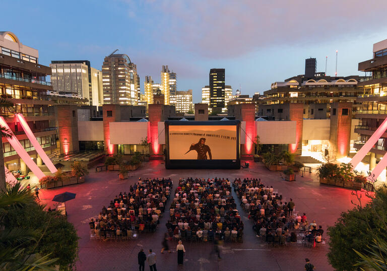 A shot of a large outdoor cinema screen in our Sculpture Court.
