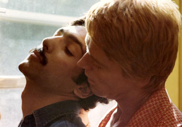 A still from Adam & Yves, showing two men in a close embrace