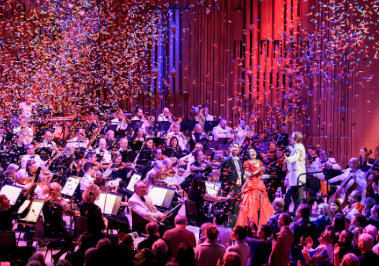 Mid-performance image of the London Concert Orchestra with confetti falling everywhere