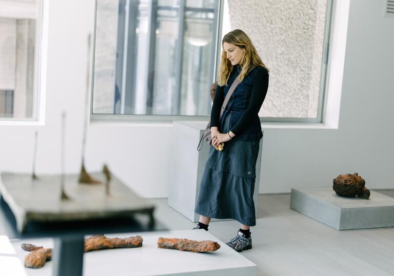 A young woman looking at artwork in a gallery