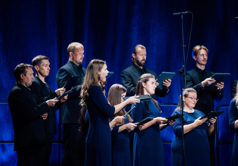 Choir dressed in dark blue singing