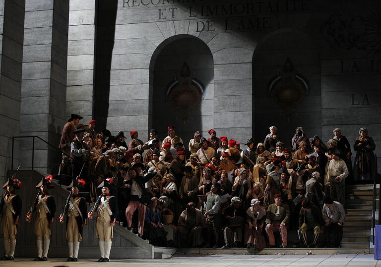 A scene froom Andrea Chenier, showing a group of French revolutionaries on the steps of a grand building