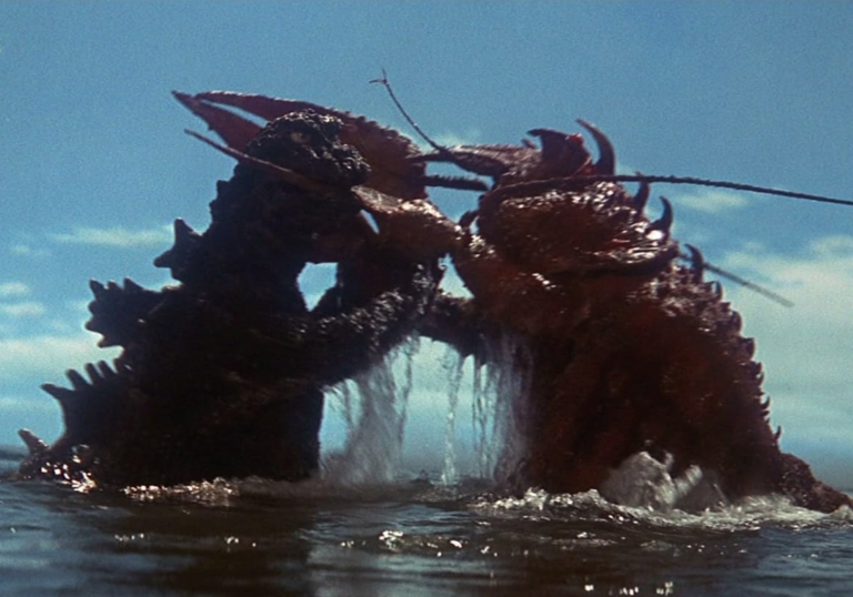 Two monsters, Godzilla and Ebirah, locked in combat in the sea