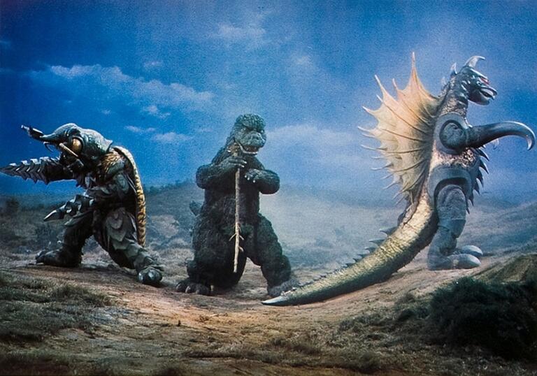 Godzilla, Megalon and Gigan standing in a row