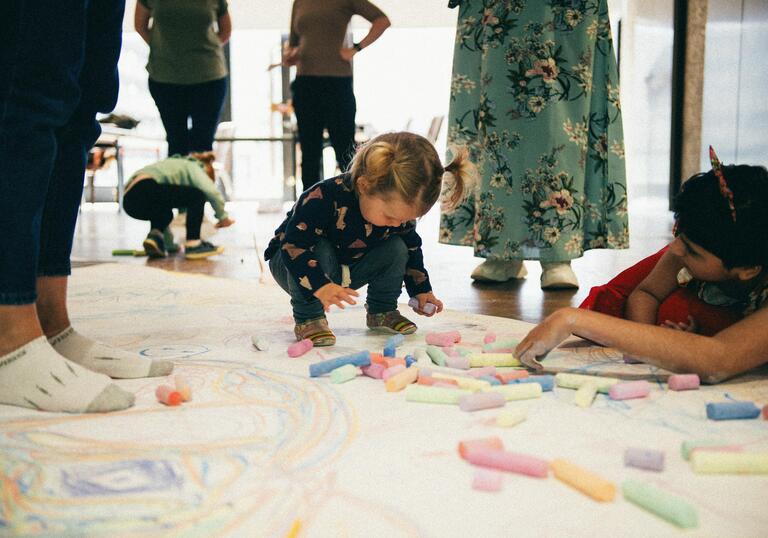 Young children drawing with chalk