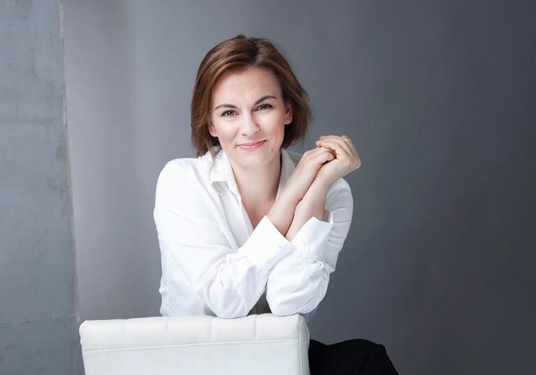 Conductor Daniela Candillari wearing white shirt with hands clasped