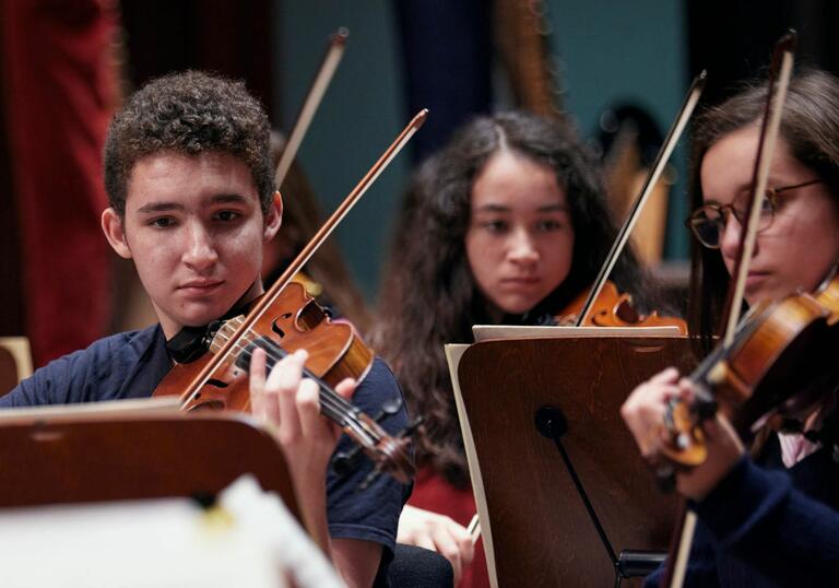 Junior Guildhall Symphony Orchestra violin players