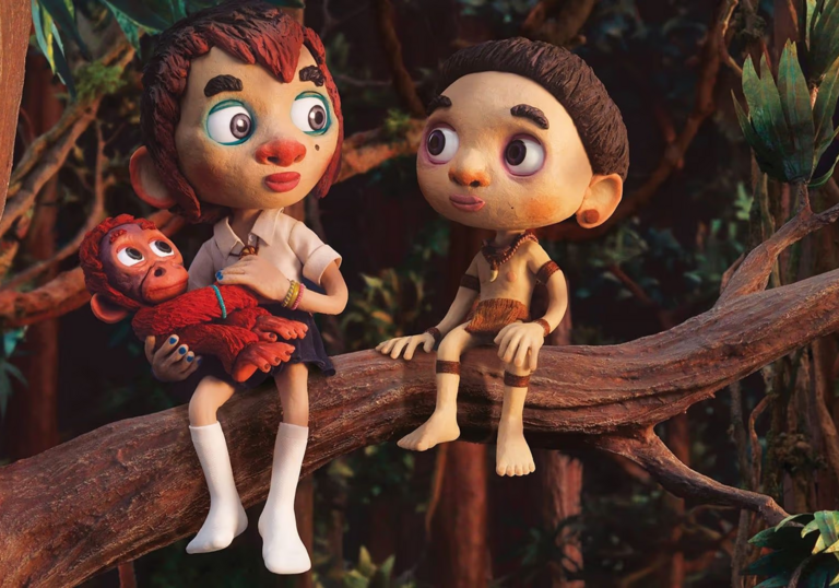 Two young people sit on a tree branch with an orangutang