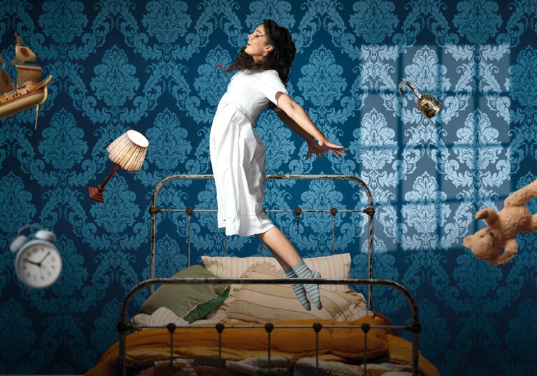 A person starts to fly in the air, levitating above their bed