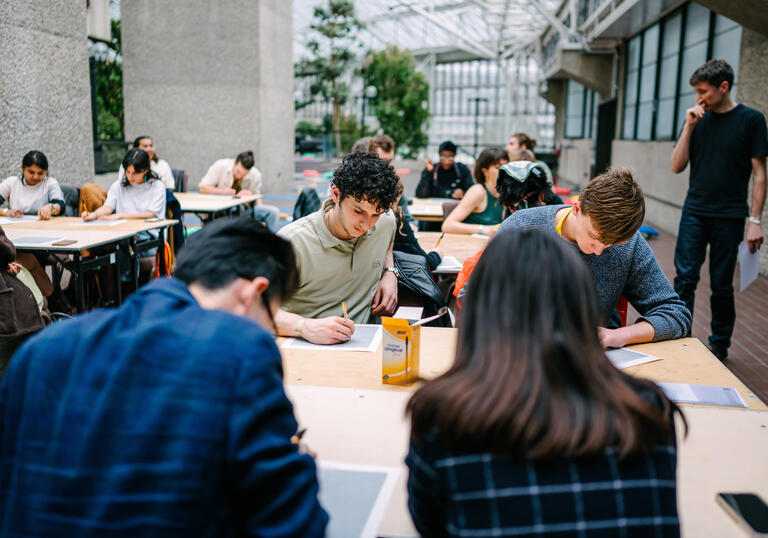 A group of people drawing, engaged in a workshop