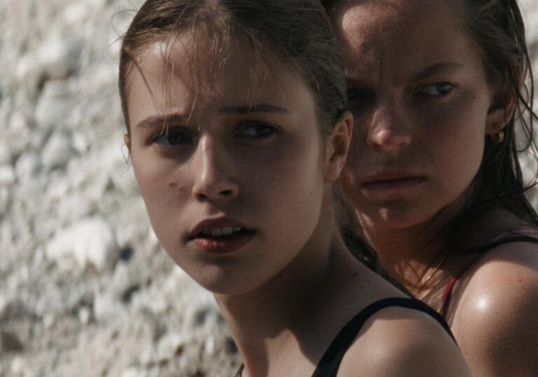 Two young girls looking into the distance.