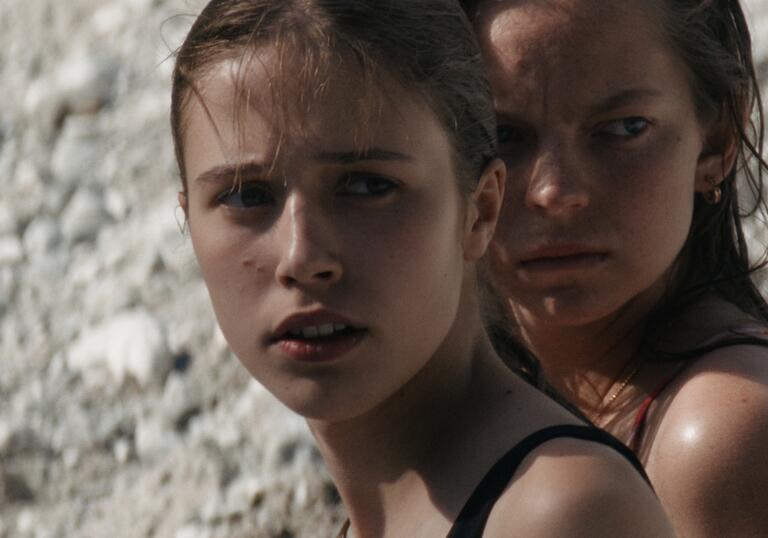 Two young girls looking into the distance.