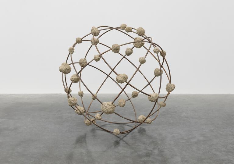 Mona Hatoum's sculpture Orbital - a spherical structure, resembling a globe, made from steel reinforcement bars and clumps of rough concrete 