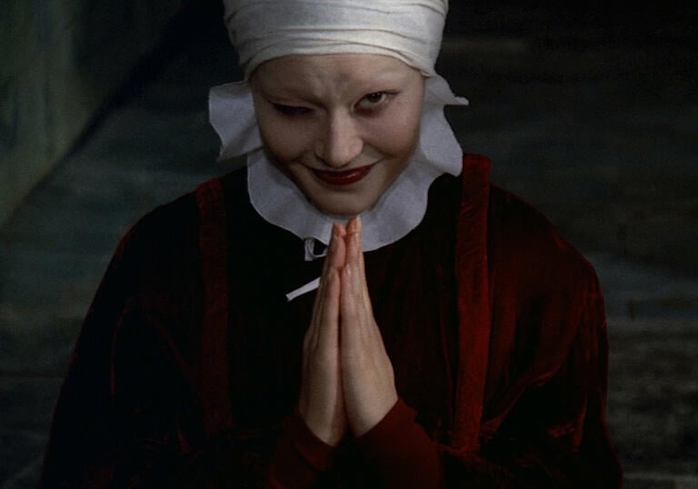 a women winking with her hands together