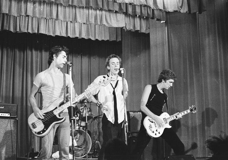 young man on stage with guitar 