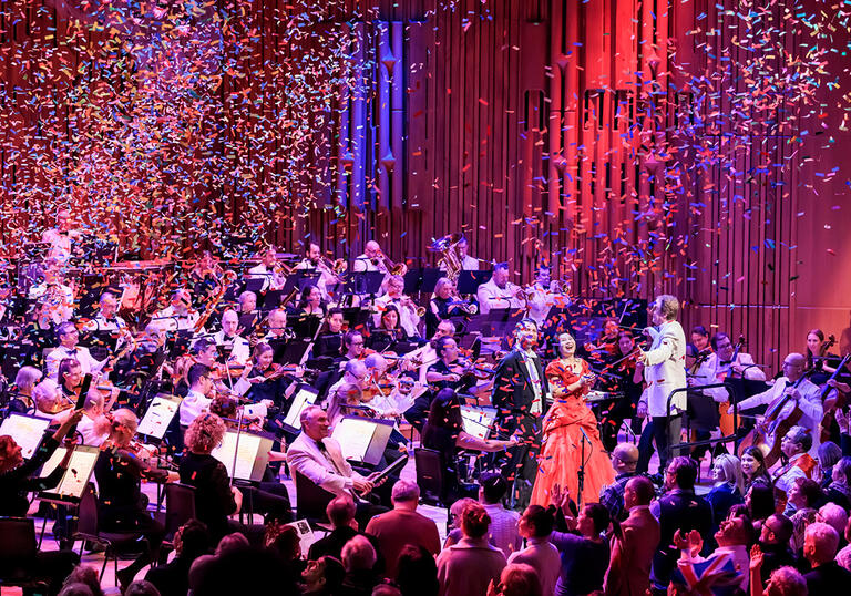 Confetti falling over an orchestra on stage