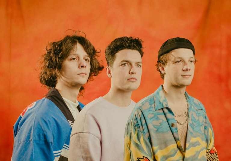 An image of the band Immortal Onion in front of an orange background