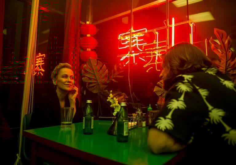 A woman talking with a man in a Chinese restaurant 