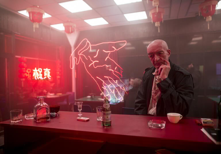 An image of a man looking pensive at a bar