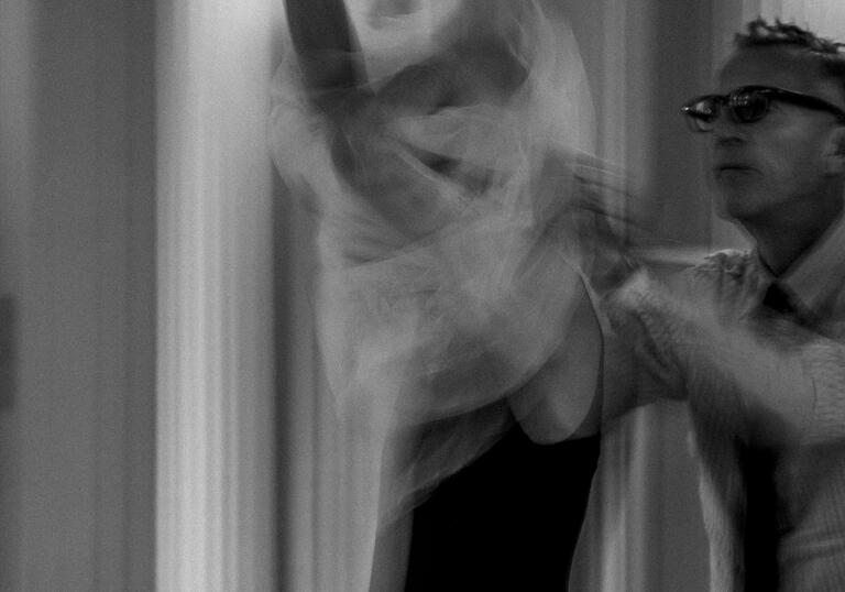 Olivier Sallaird dresses a model in a wedding dr4ess