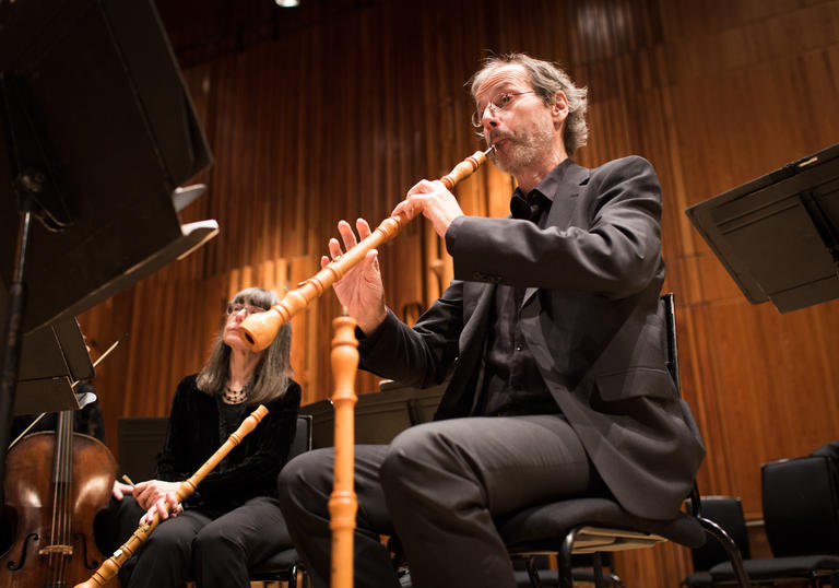 Photo of man playing an instrument in an orchestra