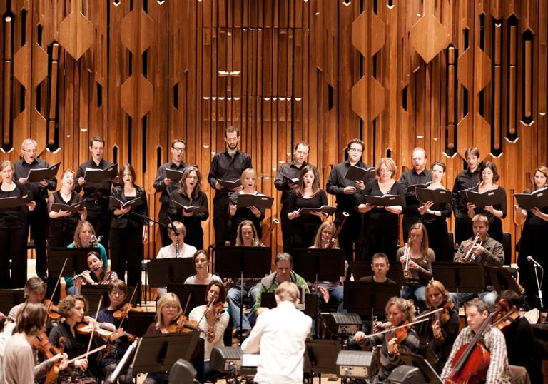 A landscape image of Britten Sinfonia Voices on stage