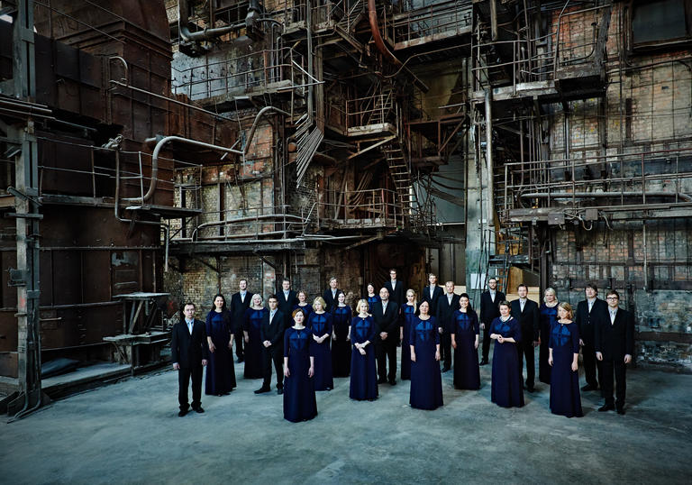 Photo of Estonian Chamber Choir against an industrial background