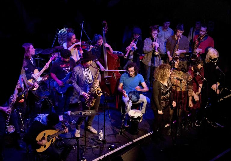 Photo of Impossibilities band performing on stage