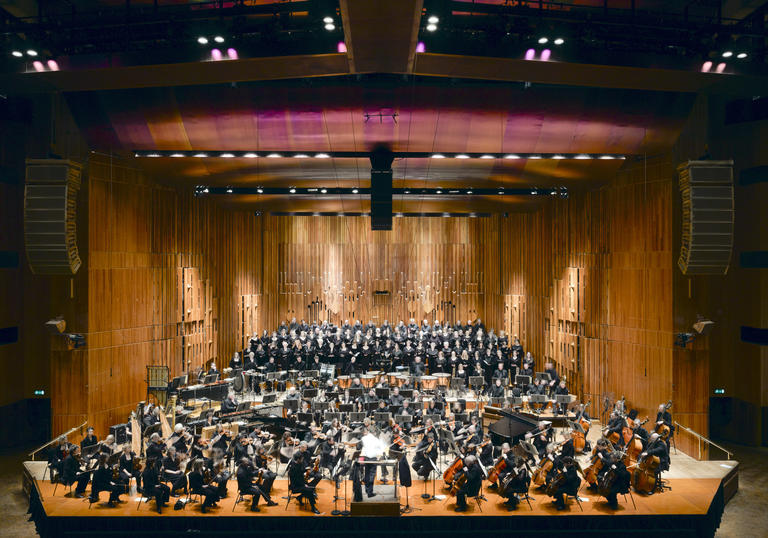 A photo of the Barbican Concert Hall with orchestra playing