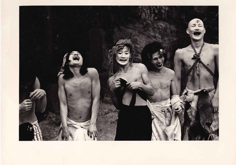 Photo of scene from Mr O's Book of the Dead film featuring a group of men in tribal makeup laughing