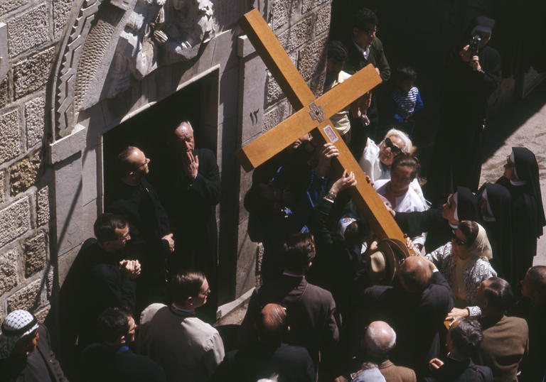 Photo of large cross being carried during performance of St John Passion